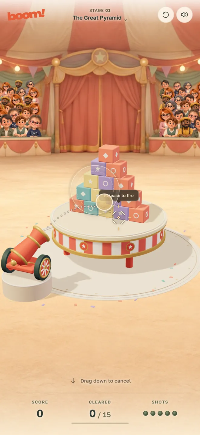 BOOM! on iPhone: aiming the circus cannon at a pyramid of props, with the sight reading Release to fire